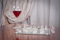 Glass with red wine and pieces on the chessboard. Set of chess figures on the playing board near a glass with red win Royalty Free Stock Photo