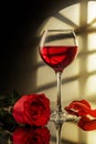 A glass of red wine and a red rose Royalty Free Stock Photo
