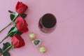 Wine glass with red roses and chocolates. Valentine`s Day Royalty Free Stock Photo