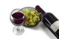 Glass of red wine, ripe green grapes, a bottle of wine Royalty Free Stock Photo