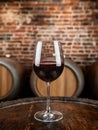 glass of red wine in a rustic winery setting Royalty Free Stock Photo