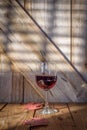 Single glass of red wine on wood table Royalty Free Stock Photo