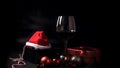 Glass of red wine with Santa Claus hat Royalty Free Stock Photo