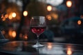 Glass of red wine on a table of outdoor restaurant in european city. Generative AI