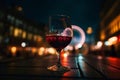 Glass of red wine on a table of outdoor restaurant in London. City lights of English capital. Generative AI