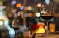 A glass of red wine on table of rooftop bar