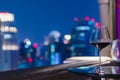 A glass of red wine on table of rooftop bar