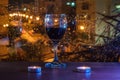 A glass of red wine with two small candles against the backdrop of rain Royalty Free Stock Photo
