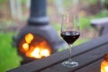 Relaxing with a glass of red wine by a warm cosy fire