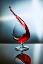 Glass of red wine with wave on blue background Royalty Free Stock Photo