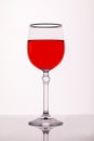 A glass of red wine on a white background with a reflection Royalty Free Stock Photo