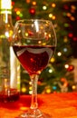 Red wine and bottle with bokeh tree background