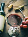 Glass of red wine, wine bottle, grapes and corkscrew blurred at the vackground. Top view Royalty Free Stock Photo