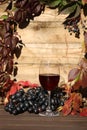 glass of red wine on wooden background with autumn leaves Royalty Free Stock Photo