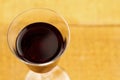 Glass of red wine on wooden background, close up.