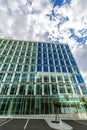 Glass reflective office buildings against blue sky with clouds and sun light Royalty Free Stock Photo