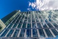 Glass reflective office buildings against blue sky with clouds and sun light Royalty Free Stock Photo