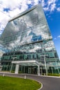 Glass reflective office buildings against blue sky with clouds and sun light Royalty Free Stock Photo