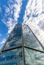 Glass reflective office buildings against blue sky with clouds and sun light Royalty Free Stock Photo