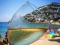 A Glass of refreshing cold white wine close up on beach restaurant. Royalty Free Stock Photo