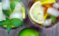Glass of refreshing drink. glass of cold water with ice, mint and lemon on a wooden table. top view Royalty Free Stock Photo