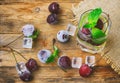 Glass with a refreshing drink, frozen cherry, lemon, lime Royalty Free Stock Photo