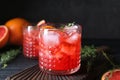 Glass of refreshing grapefruit lemonade on wooden table