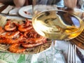 Glass of ribeiro wine and grilled prawns in a restaurant in Olveiroa village, Dumbria municipality, Galicia, Spain Royalty Free Stock Photo