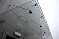 Glass roof above the entrance to the industrial building with metal cladding of the facade. thick-walled glass panel hangs above t Royalty Free Stock Photo