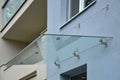 Glass roof above the entrance to the industrial building with metal cladding of the facade. thick-walled glass panel hangs above t Royalty Free Stock Photo