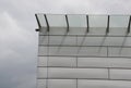 Glass roof above the entrance to the industrial building with metal cladding of the facade. thick-walled glass panel hangs above t Royalty Free Stock Photo