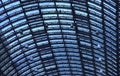 Glass roof top of a big train station in blue shade