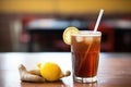 glass of root beer with a bendy straw and lemon slice Royalty Free Stock Photo