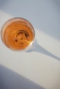 Glass with rose sparkling wine on the white table with Royalty Free Stock Photo