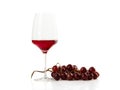 Glass of rose wine with bunch of grape isolated on white Royalty Free Stock Photo