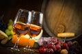 Glasses of rose wine cheeses grapesand barrel on brown wooden background Royalty Free Stock Photo