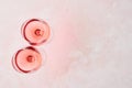 Glass of rose wine on pink background