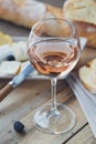 A glass of rose wine served with cheese plate, blackberries and Royalty Free Stock Photo