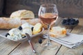 A glass of rose wine served with cheese plate, blackberries and Royalty Free Stock Photo