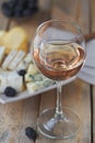 A glass of rose wine served with cheese plate, blackberries and Royalty Free Stock Photo