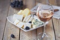 A glass of rose wine served with cheese plate, blackberries and Royalty Free Stock Photo