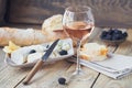 A glass of rose wine served with cheese plate, blackberries and Royalty Free Stock Photo