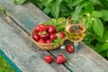 Glass of rose wine served with fresh strawberries on wooden background. Picnic outdoor with pink wine and berries Royalty Free Stock Photo