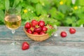 Glass of rose wine served with fresh strawberries on wooden background. Picnic outdoor with pink wine and berries Royalty Free Stock Photo