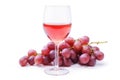 Glass of rose wine with bunch of grapes, isolated on white background.
