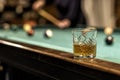 glass of Rum on a billiard table