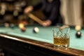 glass of Rum on a billiard table