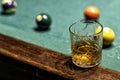 glass of Rum on a billiard table