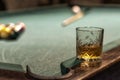 glass of Rum on a billiard table