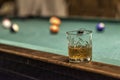 glass of Rum on a billiard table